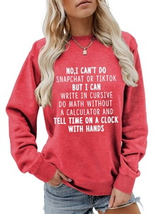 Close-up of crewneck sweatshirt in red featuring white graphic slogan text and soft fabric