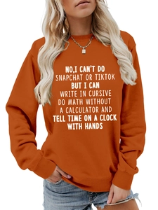 Detail of orange crewneck sweatshirt with ribbed cuffs and white slogan print