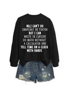 Flat lay of black crewneck sweatshirt with slogan and distressed denim shorts set