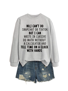 Detail of grey crewneck sweatshirt with text print and distressed denim shorts set
