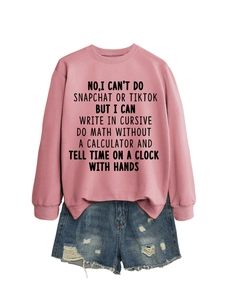 Detail of pink crewneck sweatshirt with slogan and distressed denim shorts on white background