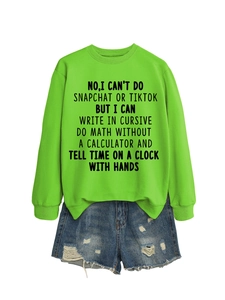 Flat lay of neon green sweatshirt with slogan text and distressed blue denim shorts