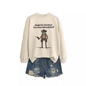 Cream sweatshirt with Frog Cowboy print and denim shorts on white background