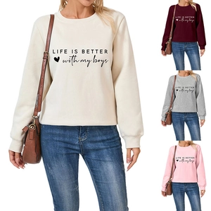 Detail of loose-fit fleece sweatshirt showing four color options with slogan print