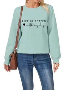 Detail of mint green sweatshirt featuring Life is better with my boys black print design