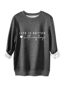Close-up of dark grey sweatshirt featuring fleece lining and Life is better slogan
