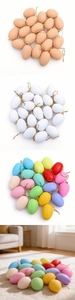 Detail of Easter DIY decorative eggs with gold hanging strings in various matte colors