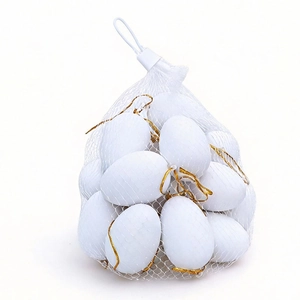 Hanging DIY Easter eggs in white finish with gold strings for festive holiday decorations