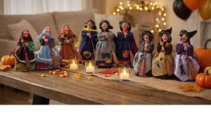 Set of 9 hanging Halloween witch figurines with colorful robes and miniature brooms