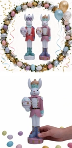 Detail of Easter bunny nutcracker resin ornaments featuring crowns and painted eggs