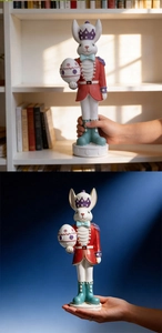 Detail of hand-painted resin rabbit soldier figurine with Easter egg and crown