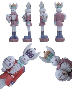 Detailed views of resin Easter bunny nutcracker soldiers with golden crowns and eggs