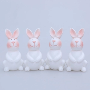 Set of four cute white plastic Easter bunny figurines with pink ears for home decor