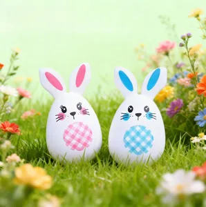 Detailed view of pink and blue Easter bunny egg statues on a sunny spring lawn