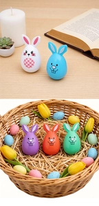 Detail of Easter bunny egg decorations in a basket with tulips and cozy home decor settings
