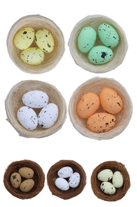 Detail of assorted colorful Easter eggs with black spots in rustic fiber nests