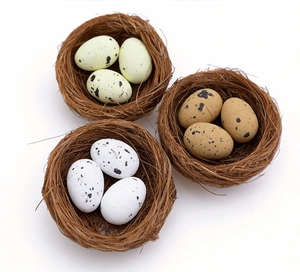 Detailed close-up of three decorative bird nests with spotted artificial Easter eggs