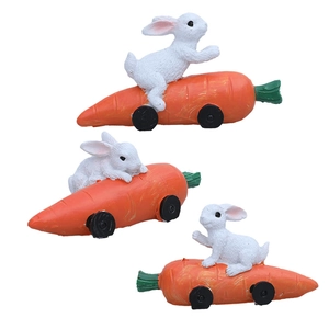 Three-piece Easter resin bunny figurines riding orange carrot cars for garden decor