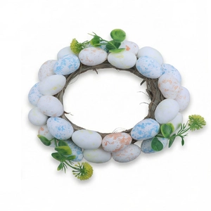 Handcrafted Easter wreath with speckled pastel eggs and green leaves on a vine base