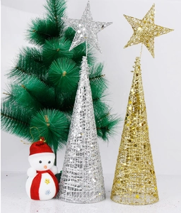 Detail of gold hollow cone and silver glitter tree toppers with a cute snowman plush