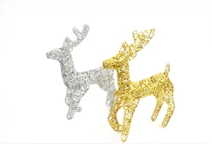 Detail of glittery silver and gold reindeer figurines made of hollowed-out metal wire