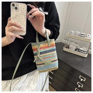 Detail of colorful striped woven mini bag with top handle and Fashion tag detail