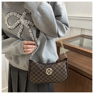 Detail of vintage brown monogram shoulder bag with metallic M buckle and gold chain strap
