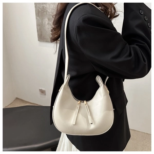 Glossy white hobo underarm bag shown with casual business attire for women