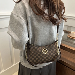 Vintage dark brown underarm bag with monogram pattern and gold M logo hardware