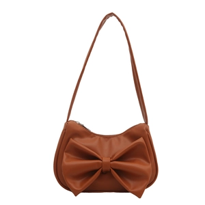 Elegant caramel brown hobo shoulder bag with a large bow detail and crescent shape