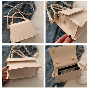 Detailed views of cream faux-crocodile handbag with magnetic closure and crossbody strap