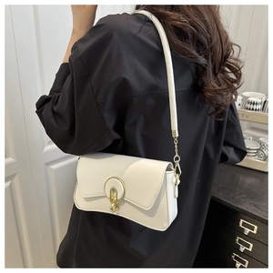 Detail of white leather shoulder bag with gold metal buckle and elegant crossbody strap