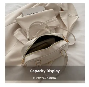 Internal capacity display of the cream white crossbody bag showing phone and wallet