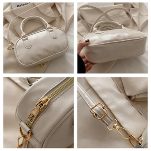 Detailed views of cream Boston bag showing gold hardware, zipper and leather texture