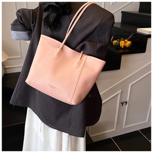 Pink lychee texture leather tote bag with FASHION & BAGS lettering shown on model