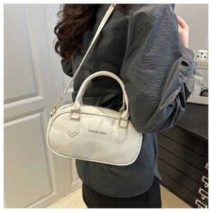 Detail of white leather Boston bag with FASHION & BAGS logo and detachable strap