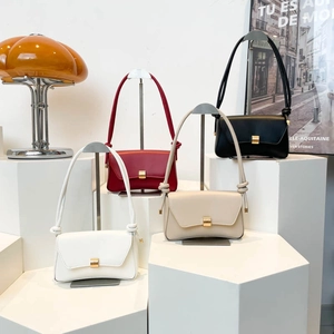 Minimalist baguette bags in four colors featuring golden buckles and knot strap details
