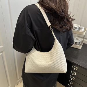 Minimalist beige woven hobo bag with a stylish half-moon design and leather shoulder strap