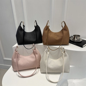 Minimalist hobo shoulder bags in oil wax leather with four colors on white display stands