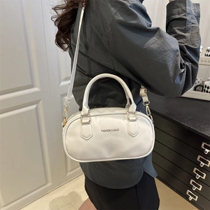 Minimalist white PU leather crossbody bag with dual handles and elegant 'FASHION & BAGS' text