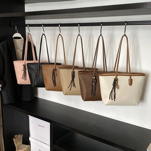 Minimalist bucket tote bags in six colors with decorative striped knot pendants