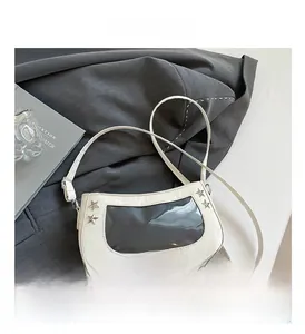 Detail view of the white shoulder bag featuring a clear window and silver star rivets