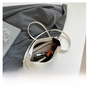 Detail showing the spacious interior of this white shoulder bag with star metal accents