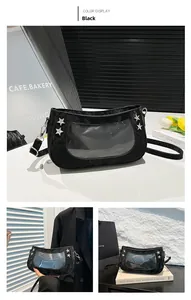 Detail of black moon-shaped Ita bag with clear PVC window and silver star studs