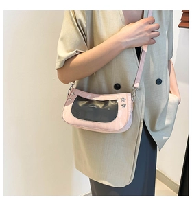 Detail of pink and black ita bag showing transparent PVC window and silver star studs