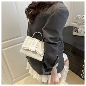 White faux leather crossbody bag with crocodile pattern texture and silver chain strap