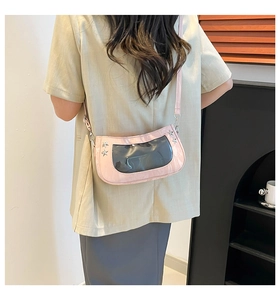Detail of pink ita bag with transparent window and silver star studs on crossbody strap