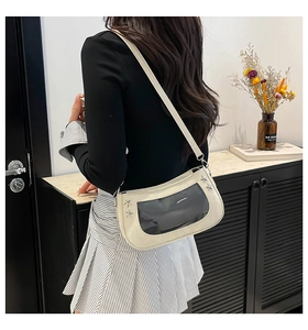 Detail of off-white shoulder bag with transparent PVC window and silver star rivets