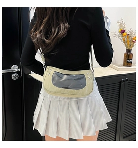 Close-up of stylish light green ita bag with transparent window and star rivet details