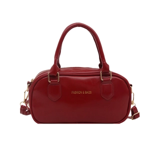 Classic red cylindrical Boston shoulder bag with gold hardware and top handles